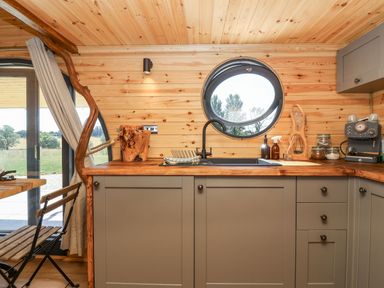 A kitchen with a sink and wooden countertop at Bugley Pools Hideaway Bugley near Gillingham
