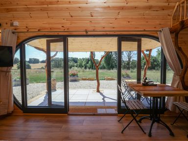 A room with sliding doors and a table at Bugley Pools Hideaway Bugley near Gillingham