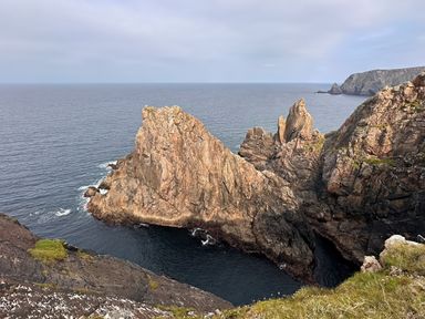 A coastal view with rock formations and ocean at Cobble Stone Cottage near Leabgarrow, County Donegal
