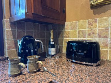 A kitchen with appliances and mugs at Cobble Stone Cottage near Leabgarrow, County Donegal
