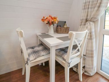 A dining area with a table and chairs at Bumblebee Glamping Pod in Malton
