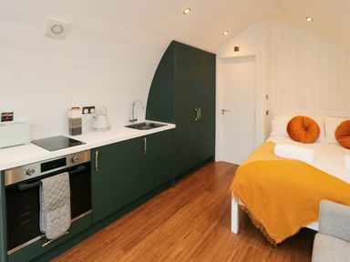 A studio with kitchen cabinets and a bed at Bumblebee Glamping Pod in Malton