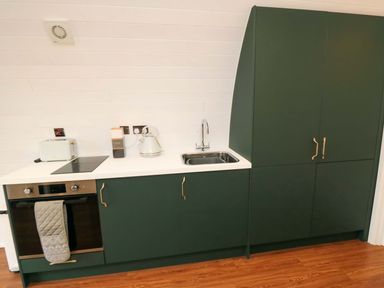 A kitchen with a sink and cooking appliances at Bumblebee Glamping Pod in Malton