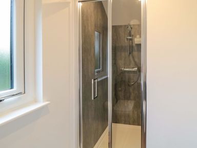 A bathroom with a shower and window at Bumblebee Glamping Pod in Malton