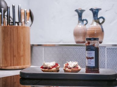 A kitchen with scones and strawberry jam on a tray at Tamarisk Cottage St. Agnes