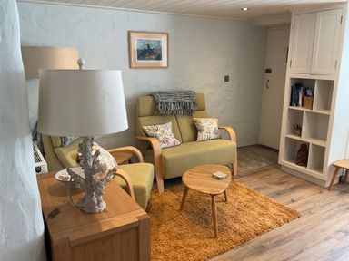 A living room with a sofa and coffee table at Tamarisk Cottage in St Agnes