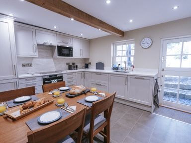 A kitchen with table and breakfast items at Bluck's cottage in St. Agnes