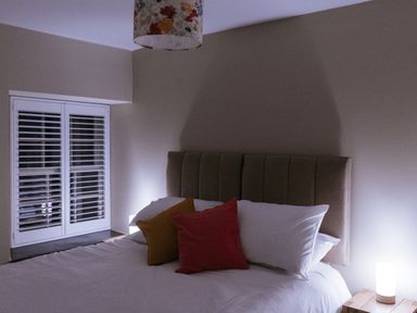 A bedroom with a bed and bedside lamp at Bluck's cottage St. Agnes