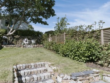 A garden with grass and a barbecue at Bluck's cottage St. Agnes
