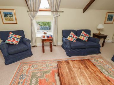 A living room with a coffee table and sofas at Honeymug in Branton near Powburn