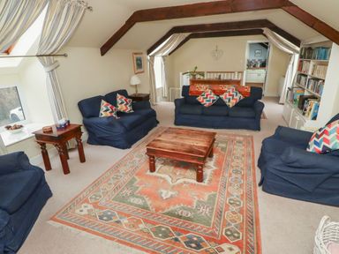 A living room with sofas and a coffee table at Honeymug in Branton near Powburn