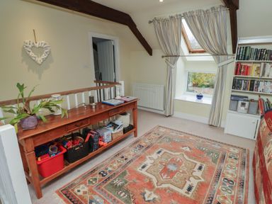 A snug with a console table and bookshelf at Honeymug in Branton near Powburn