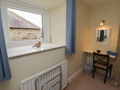 A study with a desk and mirror at Honeymug in Branton near Powburn