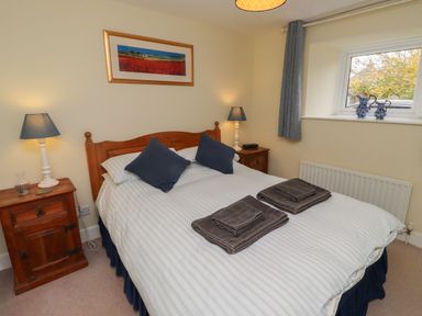 A bedroom with a bed and lamps at Honeymug in Branton near Powburn
