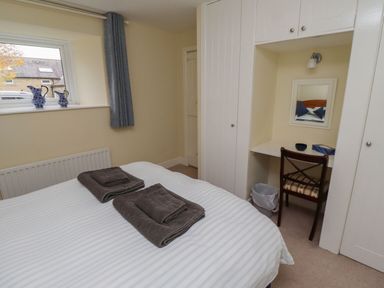 A bedroom with a bed and desk at Honeymug in Branton near Powburn