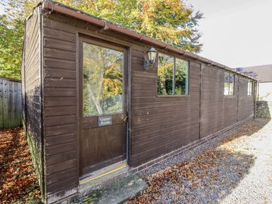 An exterior view of a games room with a door at Honeymug in Branton near Powburn