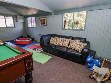 A snug with a pool table and a sofa at Honeymug in Branton near Powburn