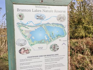 A welcome sign with a map of Branton Lakes Nature Reserve in Branton near Powburn