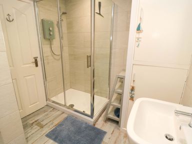 A bathroom with a shower and sink at Beach House