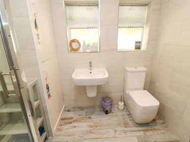 A bathroom with a sink a toilet and a shower at Beach House
