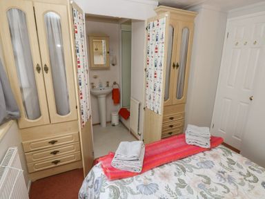 A bedroom with a bed and wardrobe at Static Caravan in 