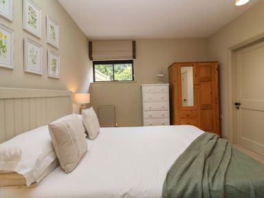 A bedroom with a bed and furniture at The Annex in Burford