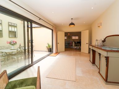 A room with a view of a dining area and outdoor seating at The Annex in Burford