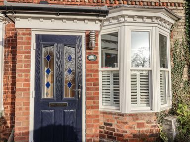 A front entrance with a door and window at 1 Castle Terrace