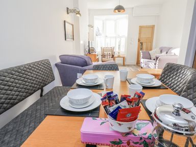 A dining area with a table set for tea at 1 Castle Terrace