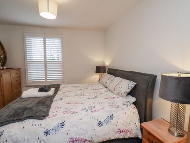 A bedroom with a bed and chest of drawers at 1 Castle Terrace Thirsk