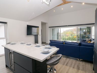 A kitchen with an island and a sofa at Cottage 1 in Laugharne