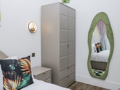 A bedroom with a bed and wardrobe at Aspen Boutique