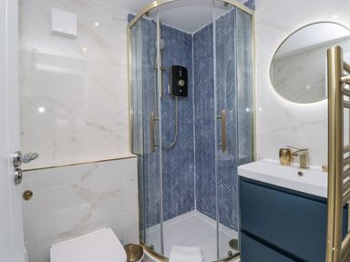 A bathroom featuring a shower, toilet, and sink at Aspen Boutique