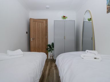 A bedroom with twin beds and a wardrobe at Aspen Boutique