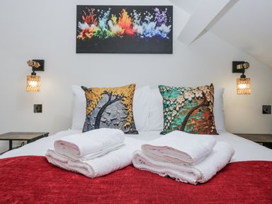 A bedroom with a bed and decorative pillows at Aspen Boutique