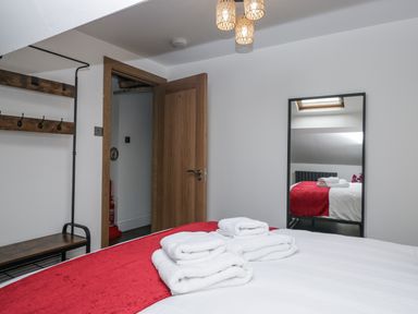 A bedroom with towels on a bed at Aspen Boutique
