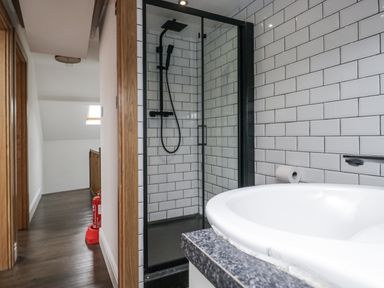 A bathroom with a shower and bathtub at Aspen Boutique 