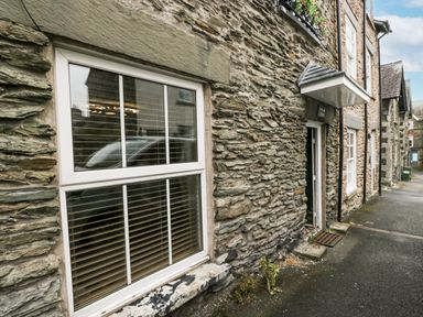 A stone building with a window and door at Aspen Boutique