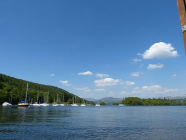 A view of a lake with boats and trees at Aspen Boutique in Windermere