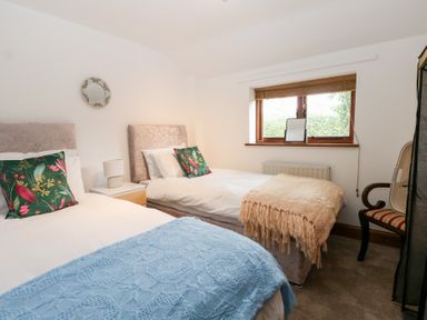 A bedroom with two beds and a window at WEST LODGE Ashford