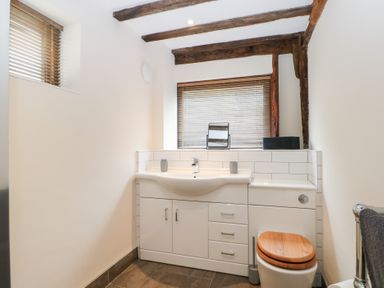 A bathroom with a sink and toilet at WEST LODGE Ashford