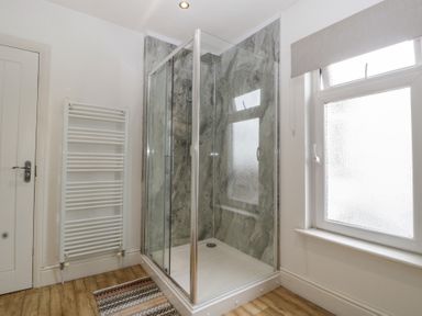 A bathroom with a shower and radiator at Gavin and Stacey House in Barry