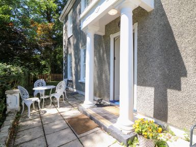 An outdoor space with a table and chairs at Ty Caredig in Swansea