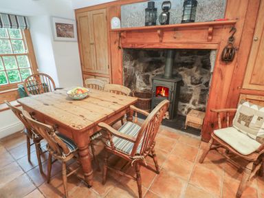 A dining room with a wooden table and chairs at 1 Rowes Cottages in Penzance