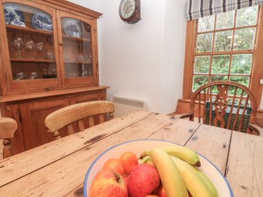 A dining table with fruit bowl at 1 Rowes Cottages Penzance