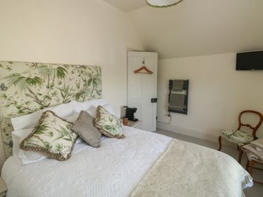 A bedroom with a bed and television at 13 School Road Newton Abbot