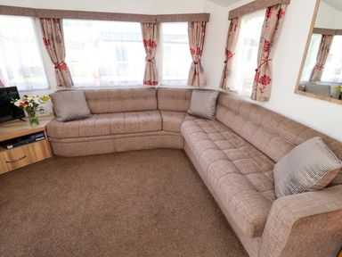 A living room with a sofa and a television at 21 Poplar Avenue in Felixstowe, Suffolk