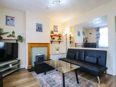 A living room with a sofa and coffee table at Dover Retreat