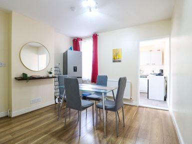 A dining room with a table and chairs at Dover Retreat