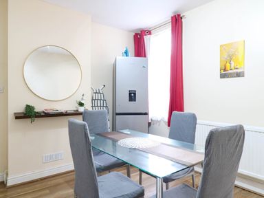 A dining room with a table and chairs at Dover Retreat
